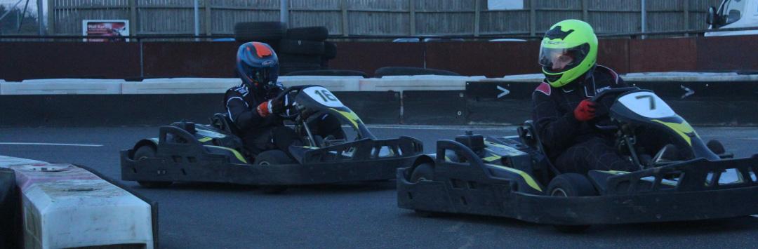 racer defending his position, looking over his shoulder at the kart behind