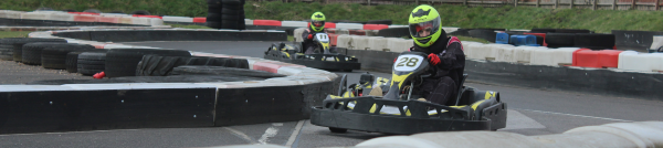 An image of karts racing around a corner